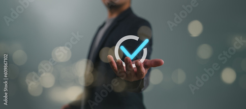 Service guarantee, Validation concept for business process automation, quality assurance management, certification, digital transformation. Businessman show checked icon on hand. Quality control.