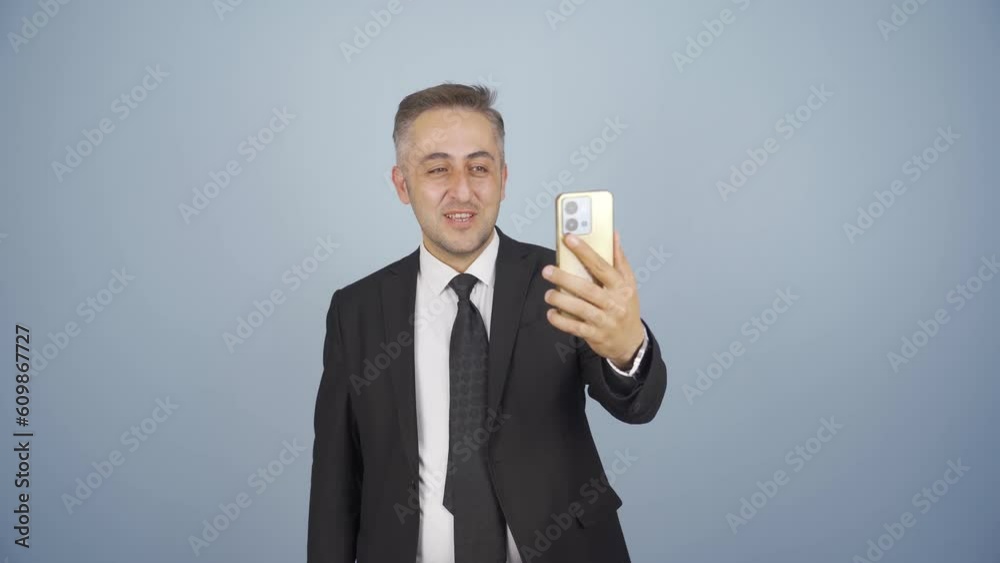 Video of businessman making video call on phone. Video of businessman making video call on phone.