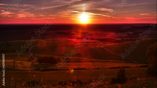 Timelapse. Sunset and nightfall over green valley, Pupillin commune in Jura region, Bourgogne-Franche-Comte in eastern France. photo
