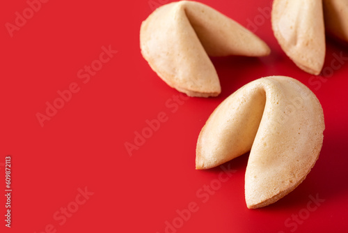Traditional fortune cookies on red background. Copy space
