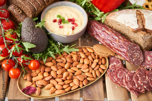 Salami sausage close-up. Table full of mediterranean appetizers, tapas or antipasto. Assorted Italian food set. Delicious snack on party or picnic time. Meat and cheese. Italian style banquet. 