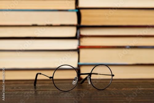 Glasses and books on the table. Concept teacher's day, study, reading, literature, development. © Plutmaverick