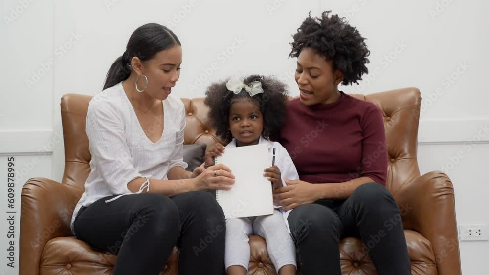 LGBT diversity Lesbian Couple Moments Happiness with her african girl laughing and drawing picture, LGBT lifestyle. LGBT diversity Lesbian Couple Moments Happiness with her african girl laughing and drawing picture, LGBT lifestyle.