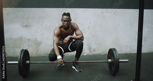 Weightlifting, fitness and portrait of black man with barbell in gym for training, exercise and workout. Strong body, muscle and male bodybuilder lift weights for challenge, wellness and strength