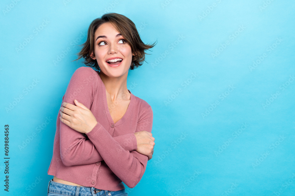 Photo of funny adorable lady hugging herself look side weather forecast wear pink shirt outfit isolated blue color background Photo of funny adorable lady hugging herself look side weather forecast wear pink shirt outfit isolated blue color background