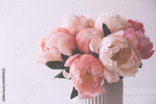 Fototapeta Naklejka Na Ścianę i Meble -  Beautiful bouquet of fresh coral peony flowers in full bloom in vase. Floral still life with blooming peonies.
