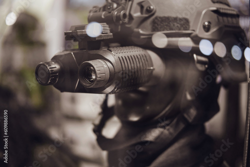 Army binoculars with night vision on a soldier's helmet. Optical device on a military helmet for tracking in war