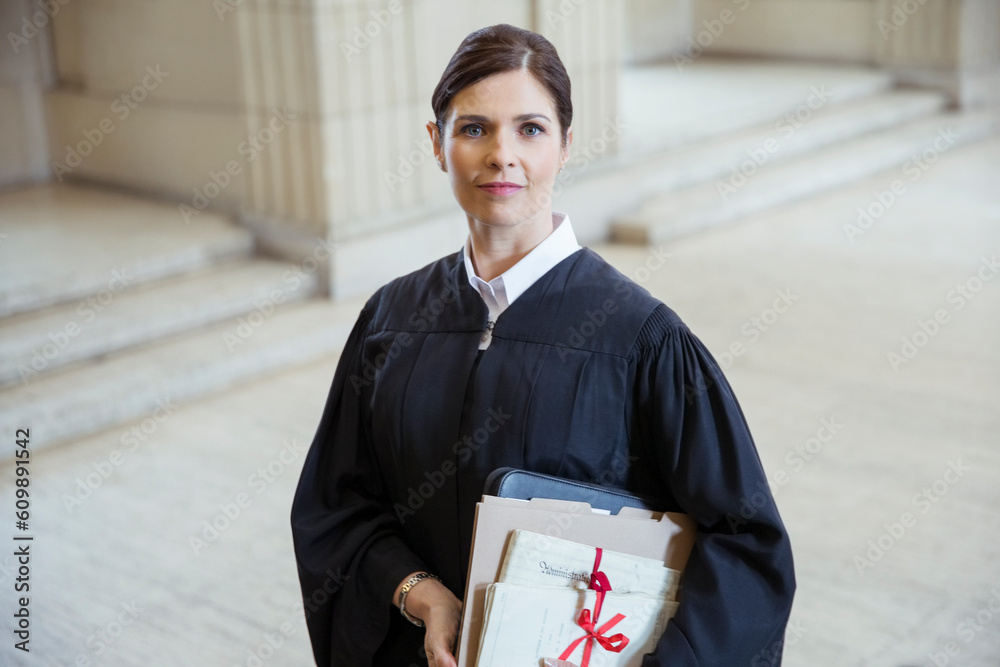 Judge holding legal documents in courthouse Judge holding legal documents in courthouse