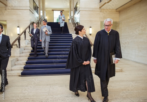 Photos Judges and lawyers walking through courthouse