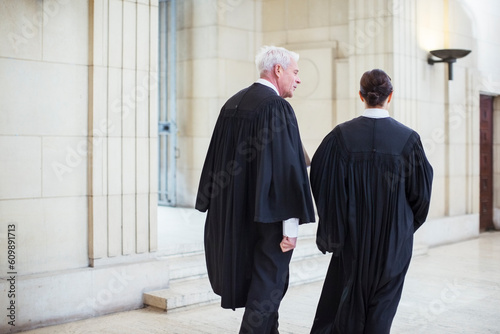 Картината върху платно Judges walking through courthouse together