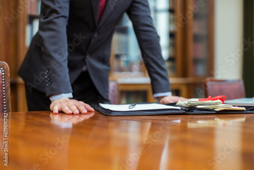 Fotografi Lawyer leaning on table in chambers