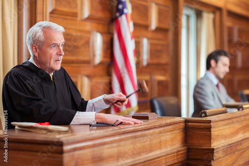 Judge banging gavel in court photo