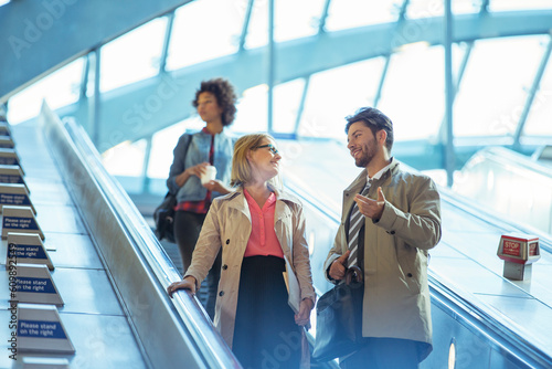 Business people talking on escalator