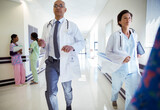 Doctors running down hospital corridor