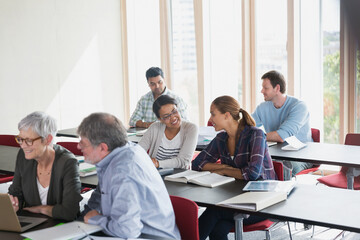 Adult education students working in pairs in classroom