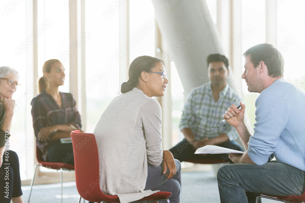Business people discussing paperwork in meeting Business people discussing paperwork in meeting