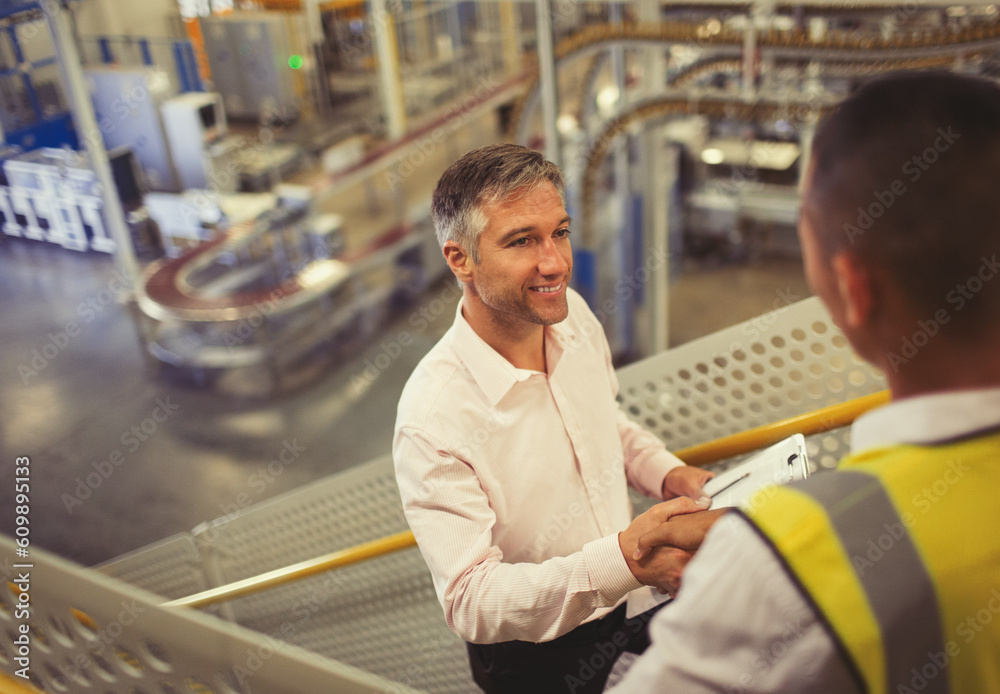 Supervisor and worker handshaking in factory Supervisor and worker handshaking in factory