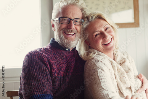 Portrait laughing senior couple hugging