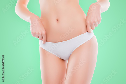Cropped close up photo of woman's skinny slim thin hips in cotton panties isolated on white background