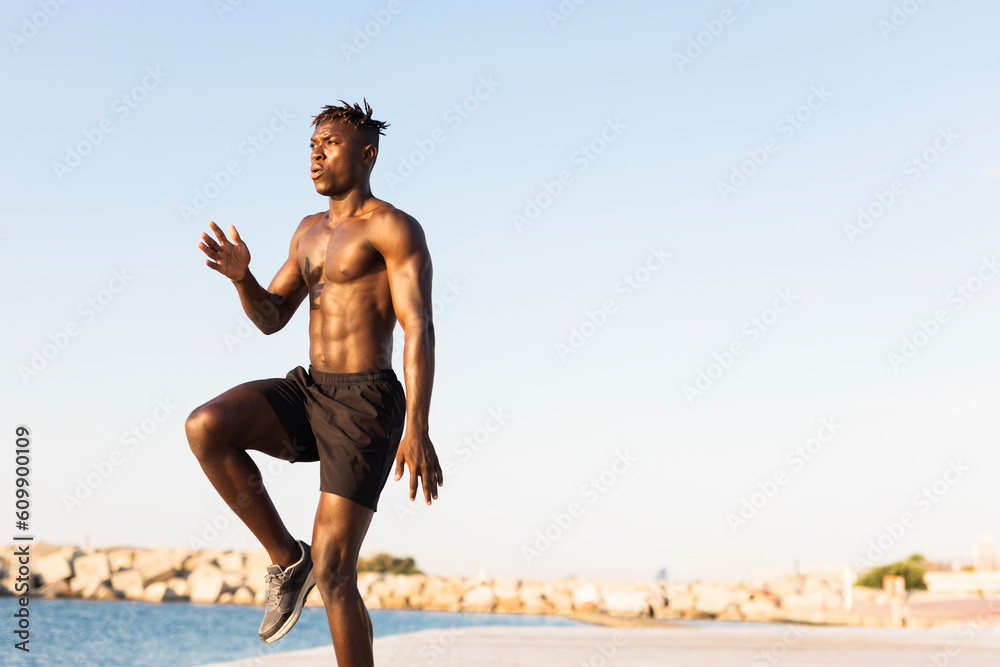 Fitness training outdoors. Handsome African man doing exercises outside. Muscular man training. Fitness training outdoors. Handsome African man doing exercises outside. Muscular man training.
