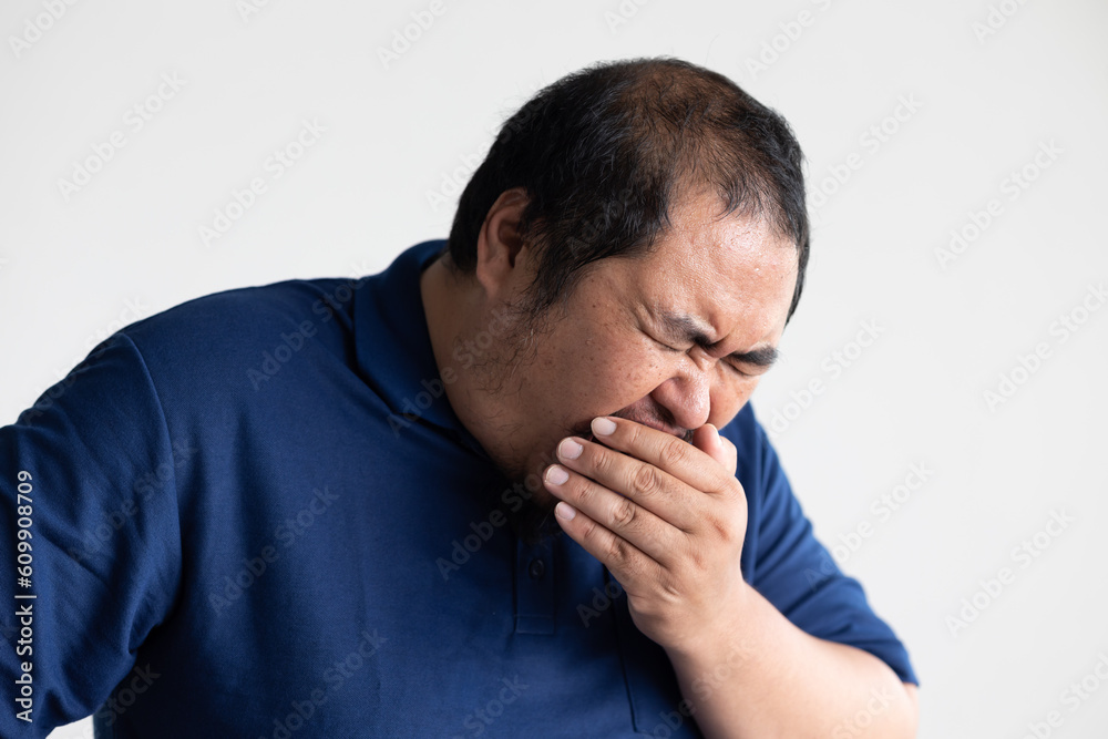 Middle aged old asian man sneezing, having sore throat irritation from cold, flu, inflammation, or infection Middle aged old asian man sneezing, having sore throat irritation from cold, flu, inflammation, or infection