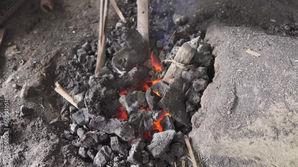 Charcoal heating of cocunut knife for bending by indian blacksmith Charcoal heating of cocunut knife for bending by indian blacksmith