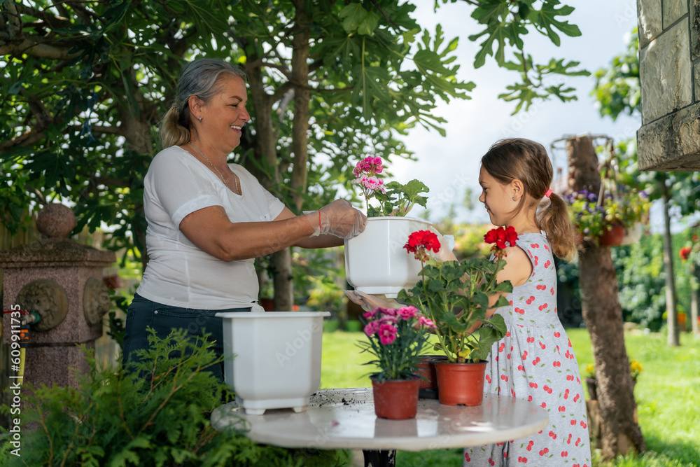 work side by side in the garden, planting and transplanting flowers. Their hands covered in soil, they nurture new life with care and love, creating a blossoming oasis in their backyard.