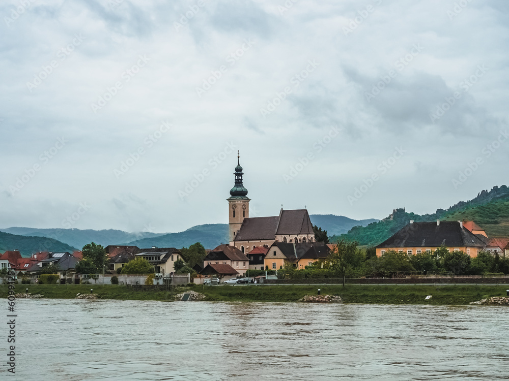 Small Austrian town on the banks of the Danube in the Wachau Valley, Austria. Beautiful village at the foot of the hill
