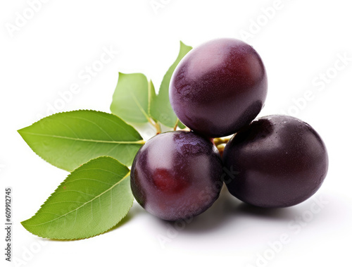 Plums with green leaves isolated on white background