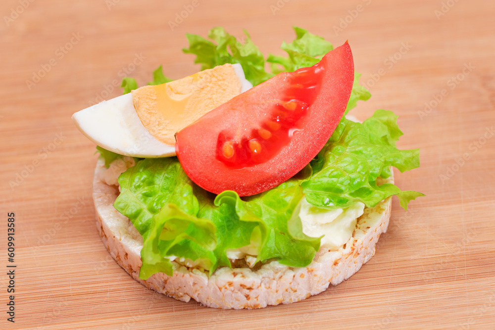 Rice Cake Sandwich with Tomato, Lettuce and Egg on Bamboo Cutting Board. Easy Breakfast. Diet Food. Quick and Healthy Sandwiches. Crispbread with Tasty Filling. Healthy Dietary Snack Rice Cake Sandwich with Tomato, Lettuce and Egg on Bamboo Cutting Board. Easy Breakfast. Diet Food. Quick and Healthy Sandwiches. Crispbread with Tasty Filling. Healthy Dietary Snack