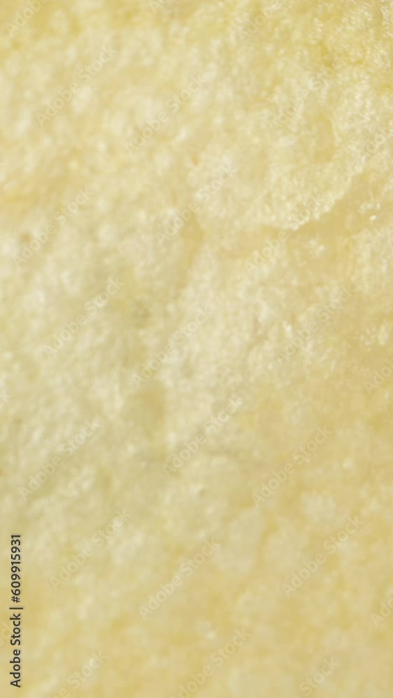 Imitation of a fall, concept. A single potato chip falls down towards the rest, captured in macro. Vertical video. Imitation of a fall, concept. A single potato chip falls down towards the rest, captured in macro. Vertical video.