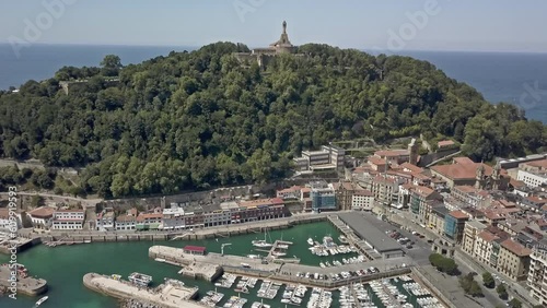 Tilt-up aerial view over the docks in San Sebastian showing Motako Gaztelua on the horizon photo