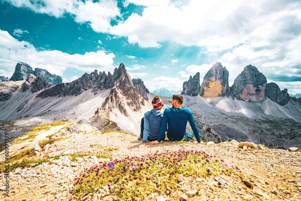 Young athletic couple enjoys summit of Sasso di Sesto in the afternoon. Tre Cime, Dolomites, South Tirol, Italy, Europe.