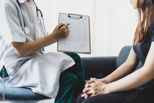 Woman visits a doctor in a hospital examination room for a check-up. Doctor examining female patient in hospital examination room. About women's health issues.