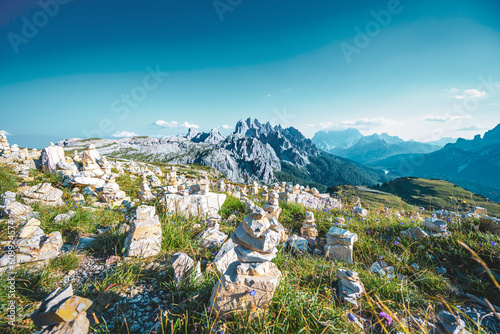 Scenic view from Dolomites high trail with flowers in the foreground in the evening. Tre Cime, Dolomites, South Tirol, Italy, Europe. © Michael
