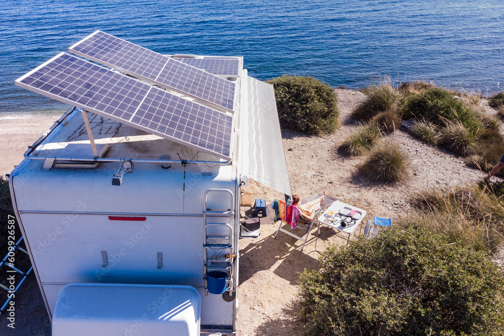 Caravan with tilt solar panels on roof. Aerial view. Stock Adobe Stock