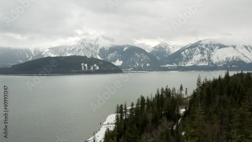 Whispers of Spring: Misty Day on Upper Arrow Lake with Snow-Capped Mountains photo