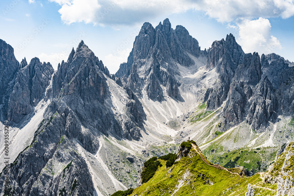 Man enjoys Cadini di Misurina mountain range from epic view point in the morning. Tre Cime, Dolomites, South Tirol, Italy, Europe.