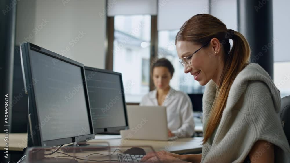 Smiling it woman programming software in office. Startup engineer checking code Smiling it woman programming software in office. Startup engineer checking code