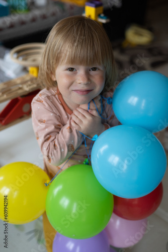 Happy child on his birthday rejoice inflatable balls