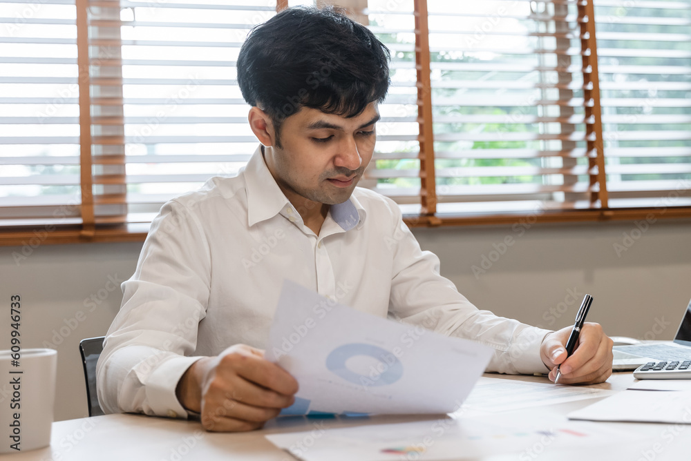 Close up hand of professional accountant review tax paperwork and signing signature on the table in workplace Close up hand of professional accountant review tax paperwork and signing signature on the table in workplace