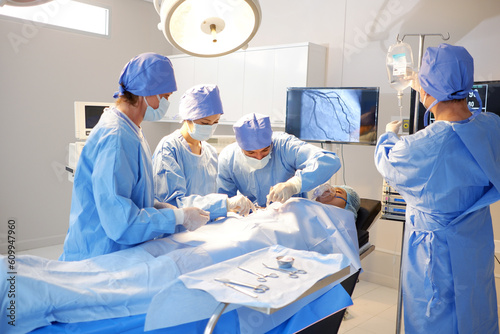 A team of doctors and medical assistants are operating on a patient inside the operating room.