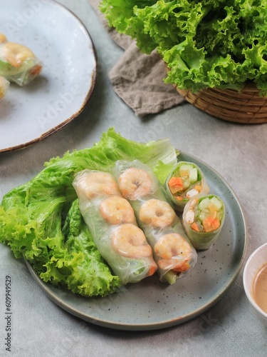 Fresh summer rolls with shrimp and vetgetables,Vietnamese food for healthy food concept with salad dressing
 photo