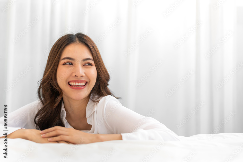 Portrait of smiling cheerful beautiful pretty asian woman clean fresh healthy white skin posing smile in in warm knitted clothes.Girl felling relax and enjoy time on the bed at home.asia beauty Portrait of smiling cheerful beautiful pretty asian woman clean fresh healthy white skin posing smile in in warm knitted clothes.Girl felling relax and enjoy time on the bed at home.asia beauty