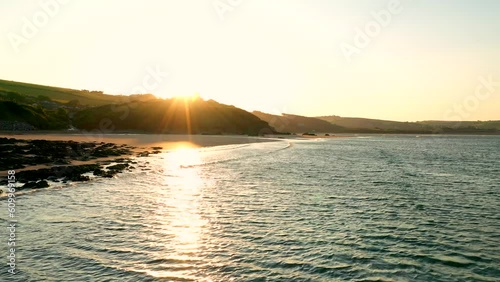 Sunrise at Bigbury Beach from over the South Devon water