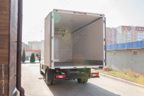 Wallpaper Mural back view of white van with opened rear doors and empty truck Torontodigital.ca