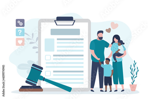 Happy multiethnic family, parents with two children. Love couple with kids standing near adoption agreement. Adoption application and gavel. Adoption papers laid out ready for completion.