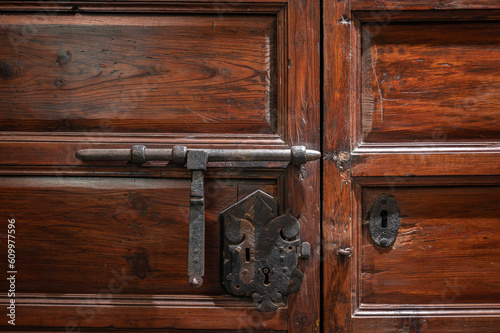 Detail of an old lock with pin of a wooden door