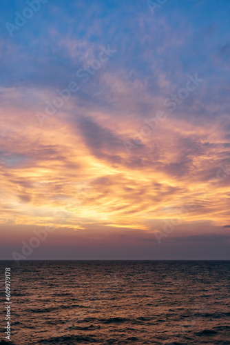 Sunset on the sea in the clouds with sun rays