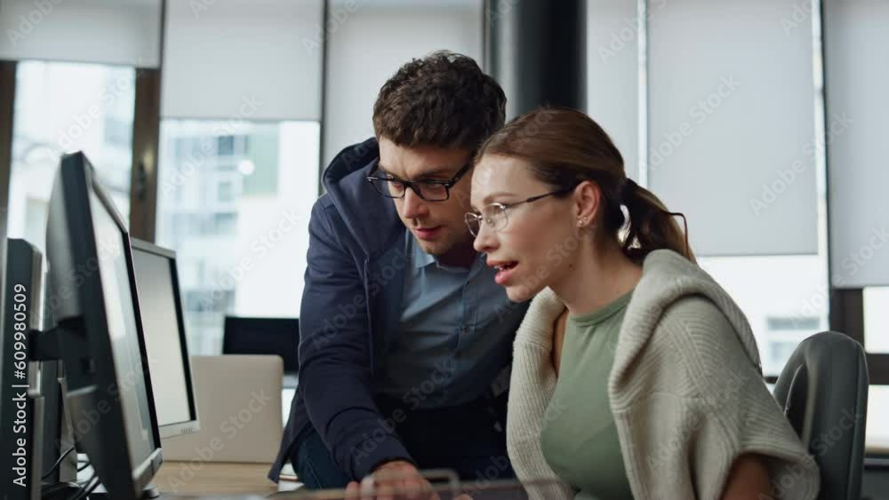It supervisor helping colleague at workplace. Friendly man engineer consulting